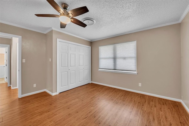1009 Robertson Ave, Copperas Cove, TX 76522 - unfurnished bedroom with light wood-type flooring, a textured ceiling, baseboards, a closet, and crown molding