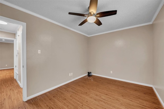 1009 Robertson Ave, Copperas Cove, TX 76522 - spare room with light wood-style flooring, baseboards, ceiling fan, a textured ceiling, and ornamental molding