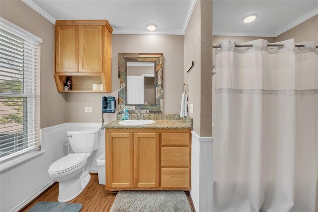 1009 Robertson Ave, Copperas Cove, TX 76522 - bathroom with toilet, wood finished floors, vanity, plenty of natural light, and crown molding