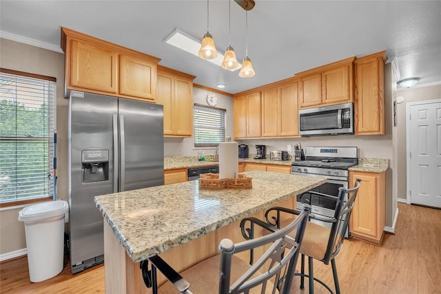 1009 Robertson Ave, Copperas Cove, TX 76522 - kitchen with stainless steel appliances, ornamental molding, light wood-type flooring, a kitchen island, and light stone counters
