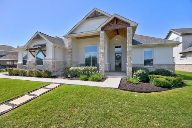 2208 Quarry Loop, Leander, TX 78641 - craftsman house featuring stone siding, stucco siding, a front lawn, and a shingled roof