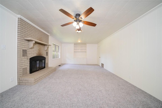 2208 US Highway 96 S, Center, TX 75935 - unfurnished living room with carpet floors, a ceiling fan, a brick fireplace, crown molding, and wood walls