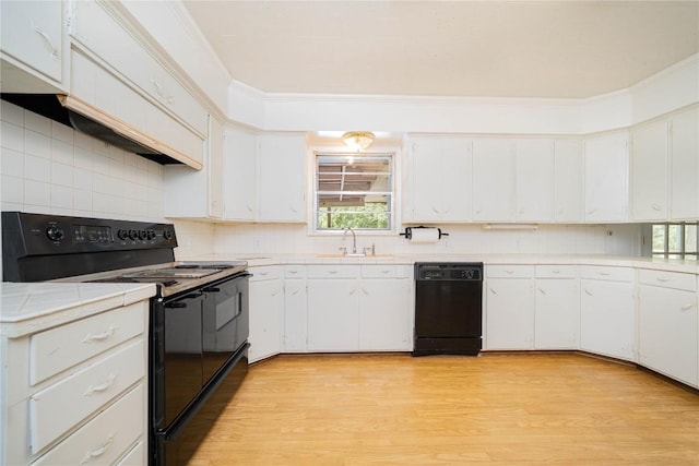 2208 US Highway 96 S, Center, TX 75935 - kitchen with black appliances, a sink, light countertops, light wood finished floors, and white cabinets
