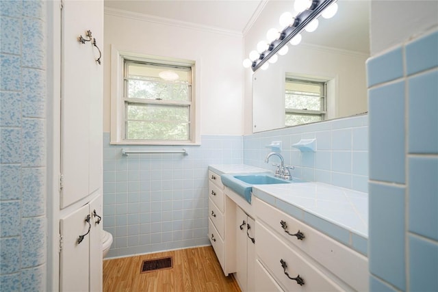 2208 US Highway 96 S, Center, TX 75935 - bathroom with vanity, crown molding, wood finished floors, toilet, and tile walls