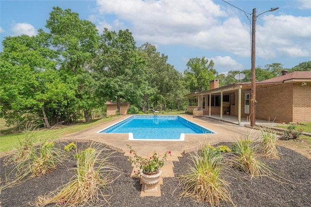 2208 US Highway 96 S, Center, TX 75935 - swimming pool featuring a patio and an outbuilding