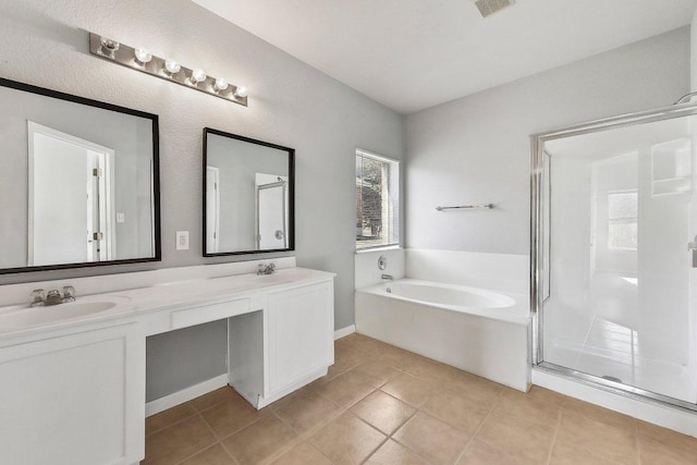164 Ashwood S, Kyle, TX 78640 - full bathroom featuring healthy amount of natural light, a bath, double vanity, and tile patterned floors