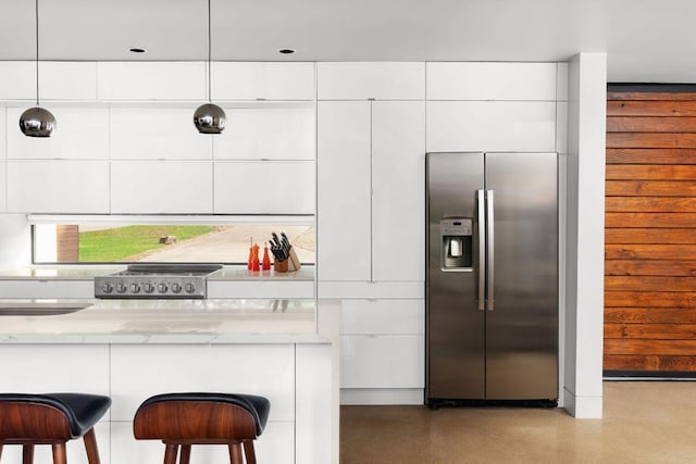 15206 General Williamson Dr, Austin, TX 78734 - kitchen featuring stainless steel fridge, modern cabinets, white cabinets, a kitchen bar, and light stone counters