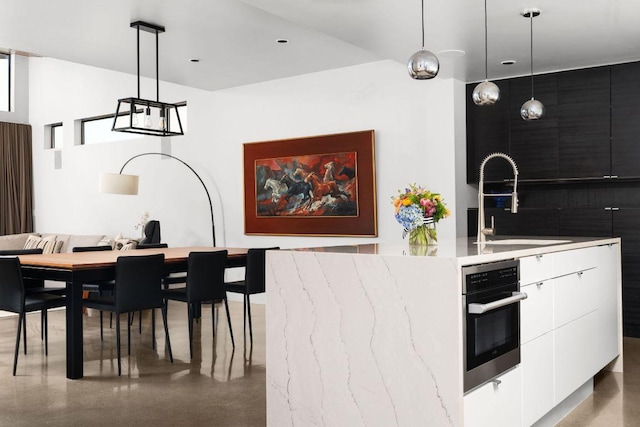 15206 General Williamson Dr, Austin, TX 78734 - kitchen with modern cabinets, oven, a sink, and decorative light fixtures