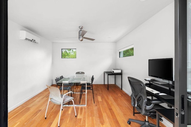 15206 General Williamson Dr, Austin, TX 78734 - home office featuring a wall unit AC, a ceiling fan, wood finished floors, and baseboards