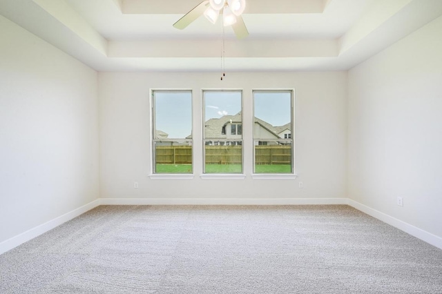 216 Ranchland Pass, Liberty Hill, TX 78642 - unfurnished room featuring a tray ceiling, carpet floors, and ceiling fan
