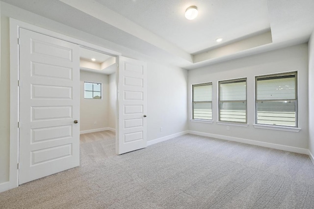 216 Ranchland Pass, Liberty Hill, TX 78642 - unfurnished room featuring a tray ceiling, carpet, and recessed lighting