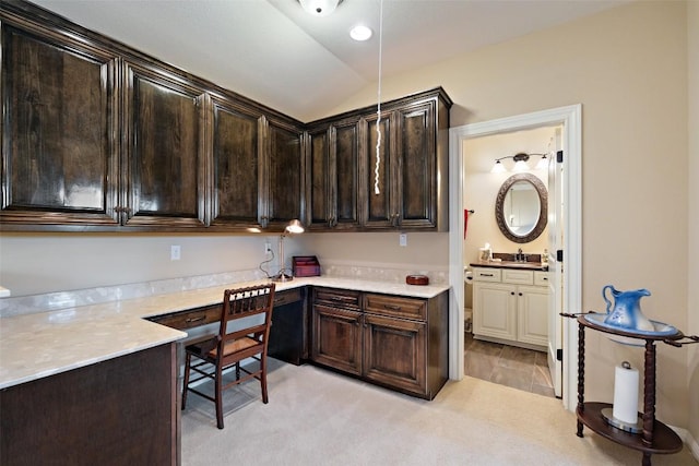 407 Bella Montagna Cir, Austin, TX 78734 - kitchen featuring dark brown cabinetry, light countertops, vaulted ceiling, a sink, and light carpet