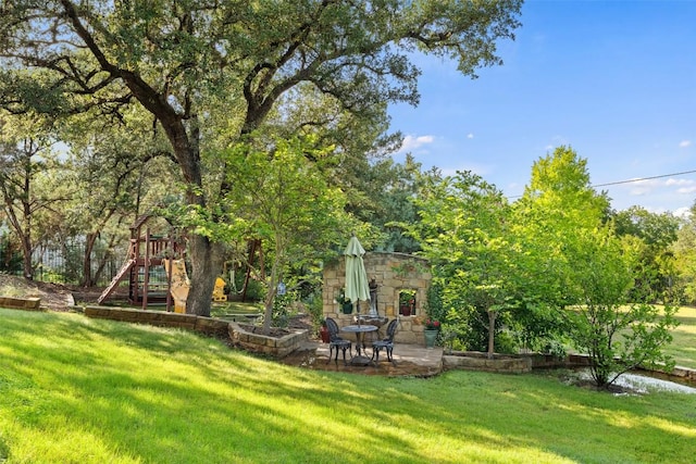 407 Bella Montagna Cir, Austin, TX 78734 - view of grassy yard featuring a playground and a patio area