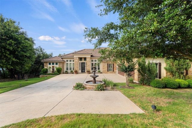 407 Bella Montagna Cir, Austin, TX 78734 - view of front facade with stone siding, a tiled roof, stucco siding, and a front lawn
