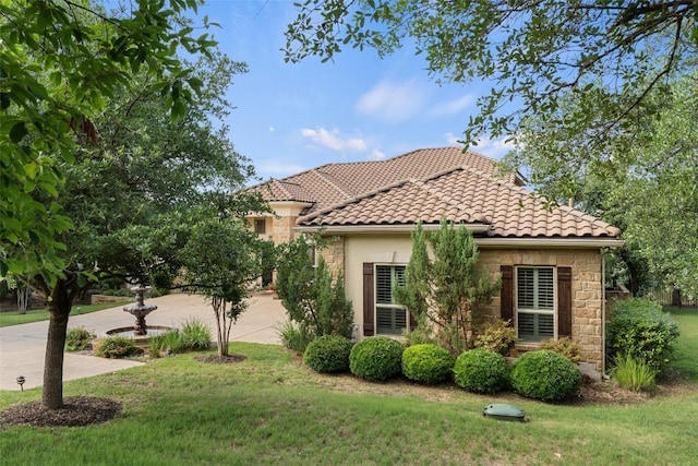 407 Bella Montagna Cir, Austin, TX 78734 - view of side of property with a yard, stone siding, a tiled roof, stucco siding, and driveway