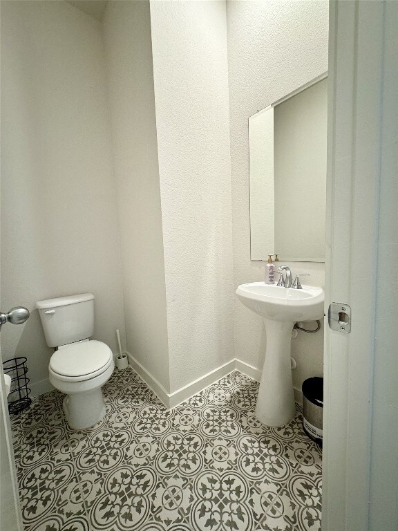 422 Billowing Way, Kyle, TX 78640 - half bathroom with toilet and baseboards