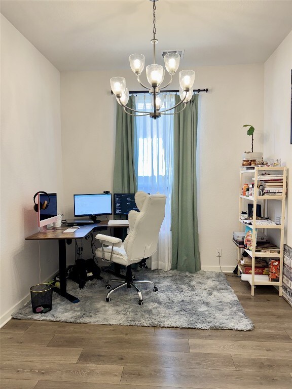 422 Billowing Way, Kyle, TX 78640 - home office featuring a chandelier, wood finished floors, and baseboards