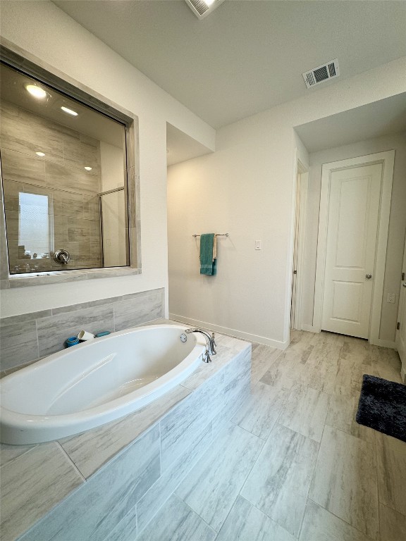 422 Billowing Way, Kyle, TX 78640 - full bath featuring a garden tub and baseboards