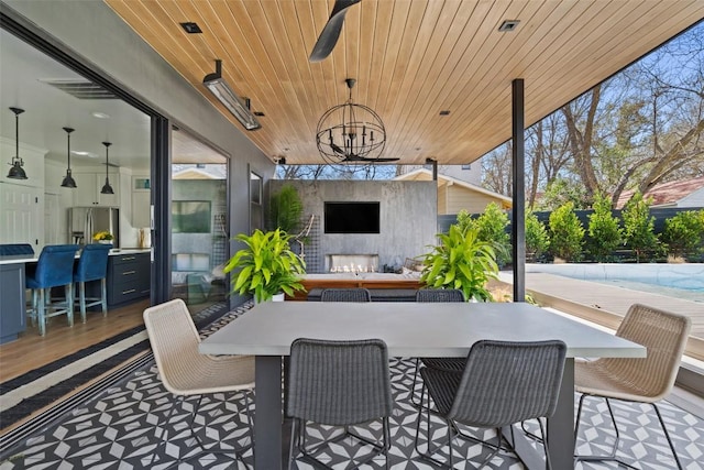 1102 Kinney Ave, Austin, TX 78704 - view of patio featuring exterior fireplace, ceiling fan, and outdoor dining area