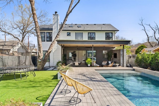 1102 Kinney Ave, Austin, TX 78704 - back of property featuring a trampoline, a patio area, and a chimney