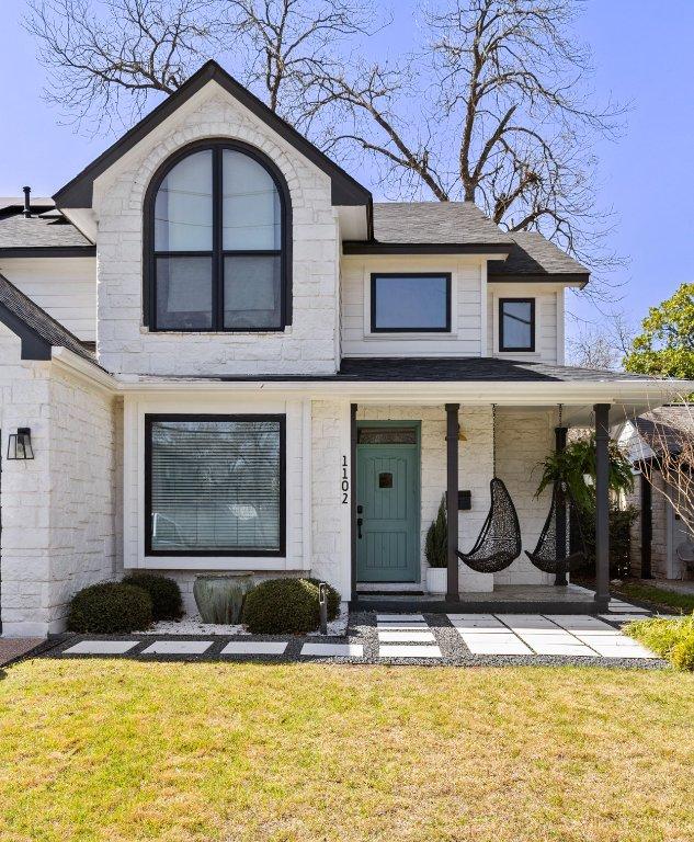 1102 Kinney Ave, Austin, TX 78704 - view of front facade with roof with shingles, a front lawn, and a porch