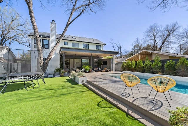 1102 Kinney Ave, Austin, TX 78704 - rear view of property with a trampoline and a chimney