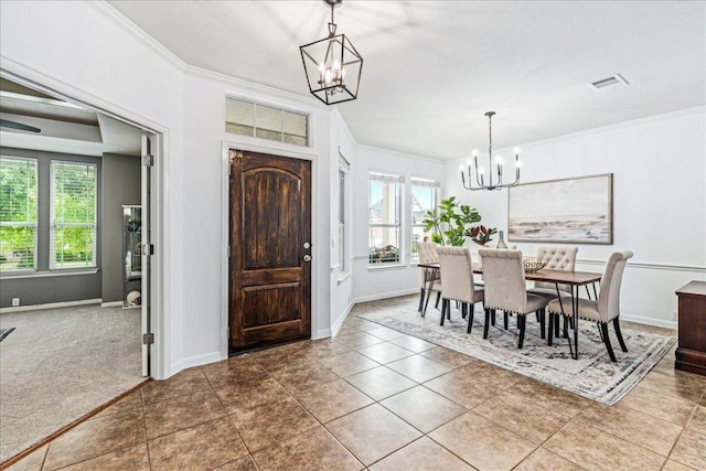 295 Desert Wilow Way, Austin, TX 78737 - carpeted dining space featuring a chandelier, healthy amount of natural light, crown molding, and tile patterned flooring