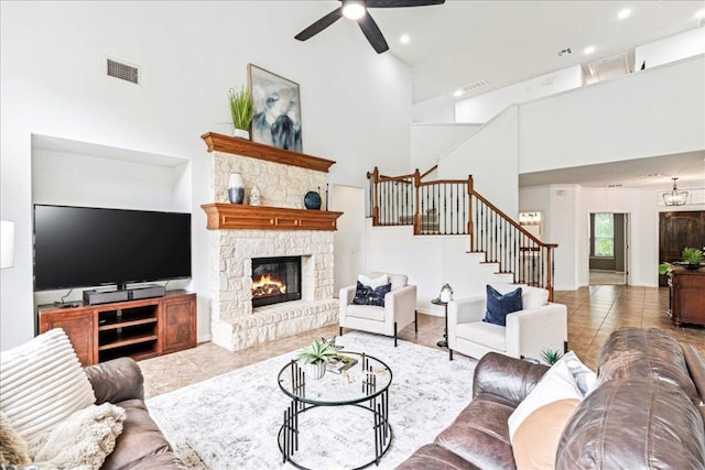 295 Desert Wilow Way, Austin, TX 78737 - living room featuring a towering ceiling, stairway, a ceiling fan, a fireplace, and tile patterned floors