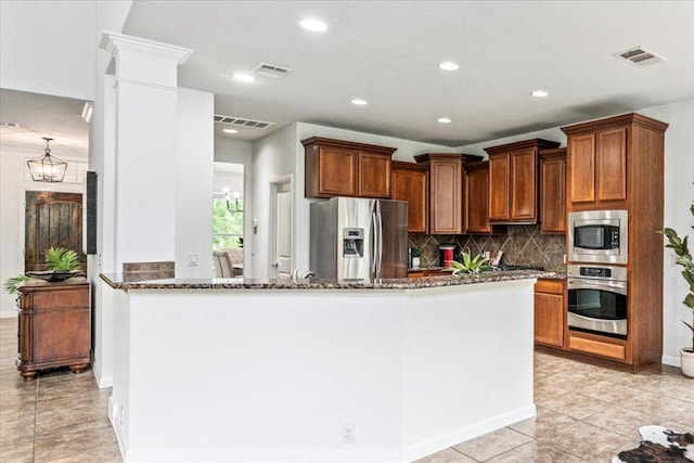 295 Desert Wilow Way, Austin, TX 78737 - kitchen featuring appliances with stainless steel finishes, dark stone countertops, tasteful backsplash, recessed lighting, and light tile patterned floors