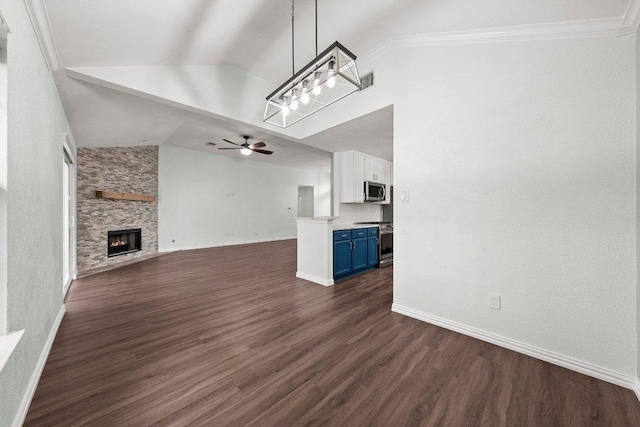 11220 Amaranth Ln, Austin, TX 78754 - unfurnished living room featuring a ceiling fan, dark wood finished floors, a stone fireplace, baseboards, and high vaulted ceiling