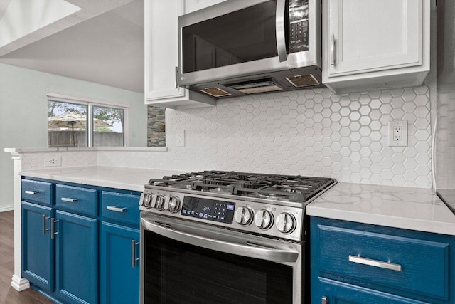 11220 Amaranth Ln, Austin, TX 78754 - kitchen featuring appliances with stainless steel finishes, blue cabinetry, and backsplash