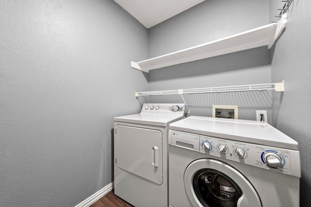 11220 Amaranth Ln, Austin, TX 78754 - laundry room featuring separate washer and dryer, a textured wall, dark wood finished floors, and baseboards