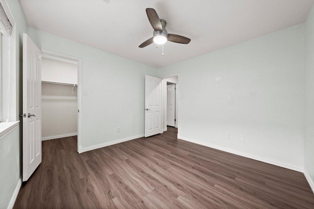11220 Amaranth Ln, Austin, TX 78754 - unfurnished bedroom with wood finished floors, baseboards, ceiling fan, a spacious closet, and a closet