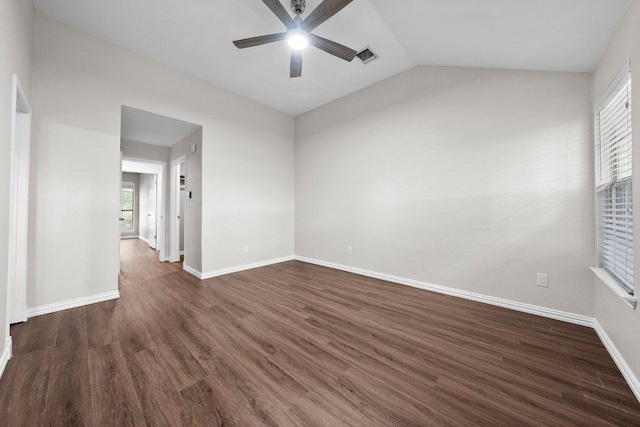 11220 Amaranth Ln, Austin, TX 78754 - spare room with ceiling fan, dark wood-type flooring, baseboards, and lofted ceiling