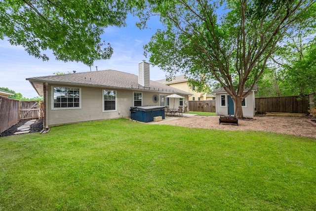 11220 Amaranth Ln, Austin, TX 78754 - back of house with a hot tub, a patio, and a chimney