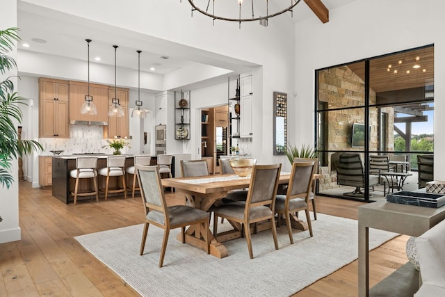 12625 Maidenhair Ln Unit 32, Austin, TX 78738 - dining area featuring light wood finished floors, plenty of natural light, a high ceiling, recessed lighting, and a chandelier