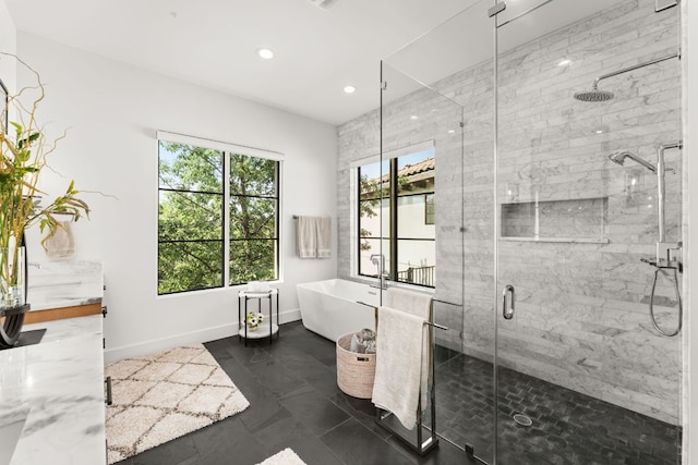 12625 Maidenhair Ln Unit 32, Austin, TX 78738 - full bath featuring a freestanding tub, a shower stall, recessed lighting, and baseboards