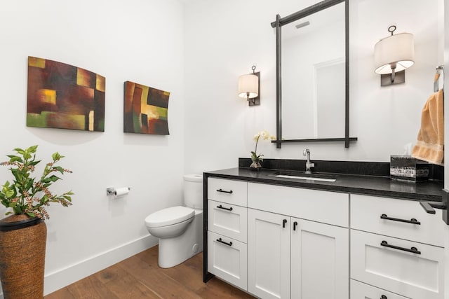 12625 Maidenhair Ln Unit 32, Austin, TX 78738 - bathroom featuring toilet, wood finished floors, vanity, and baseboards
