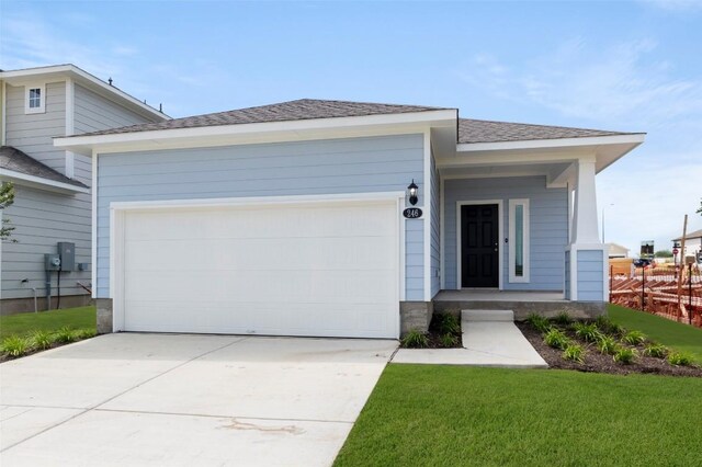 246 Barley Ln, Elgin, TX 78621 - ranch-style home featuring driveway, a garage, a shingled roof, and a front lawn
