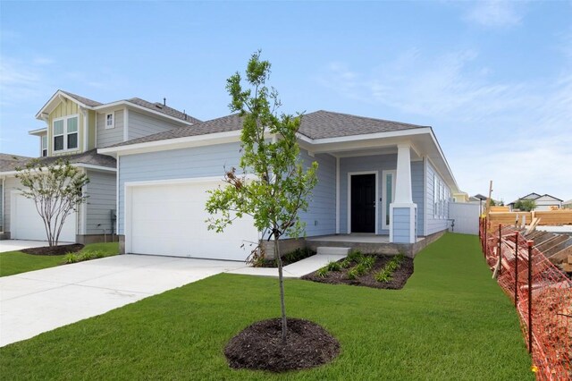 246 Barley Ln, Elgin, TX 78621 - view of front of home with driveway, an attached garage, and roof with shingles