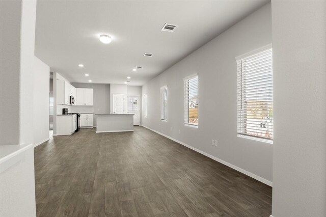 246 Barley Ln, Elgin, TX 78621 - unfurnished living room featuring dark wood-style floors and recessed lighting
