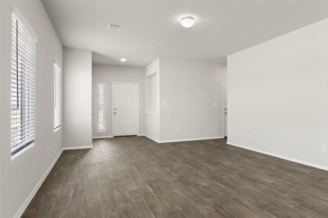 246 Barley Ln, Elgin, TX 78621 - empty room featuring dark wood-style flooring and recessed lighting