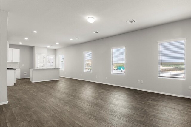 246 Barley Ln, Elgin, TX 78621 - unfurnished living room featuring dark wood-type flooring and recessed lighting