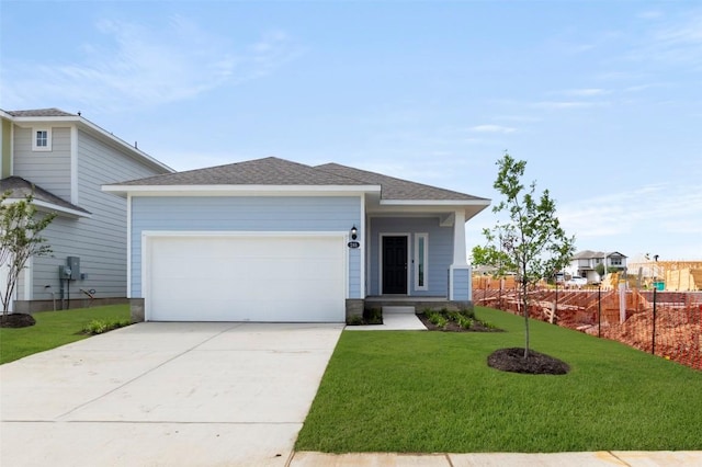 246 Barley Ln, Elgin, TX 78621 - view of front of house with concrete driveway, an attached garage, and a shingled roof