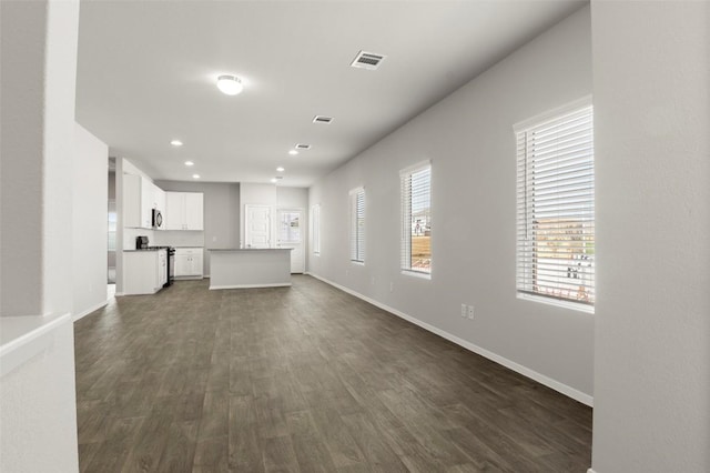 246 Barley Ln, Elgin, TX 78621 - unfurnished living room featuring dark wood-style floors and recessed lighting