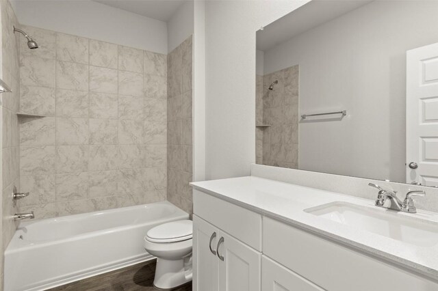 246 Barley Ln, Elgin, TX 78621 - bathroom featuring vanity, tub / shower combination, and wood finished floors