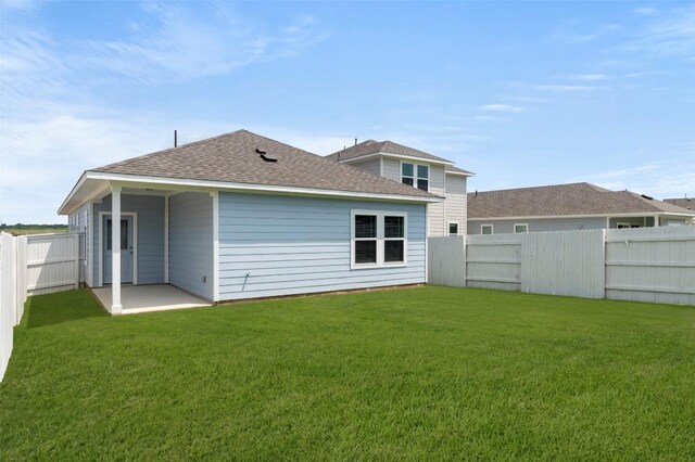 246 Barley Ln, Elgin, TX 78621 - back of property with roof with shingles, a fenced backyard, and a patio
