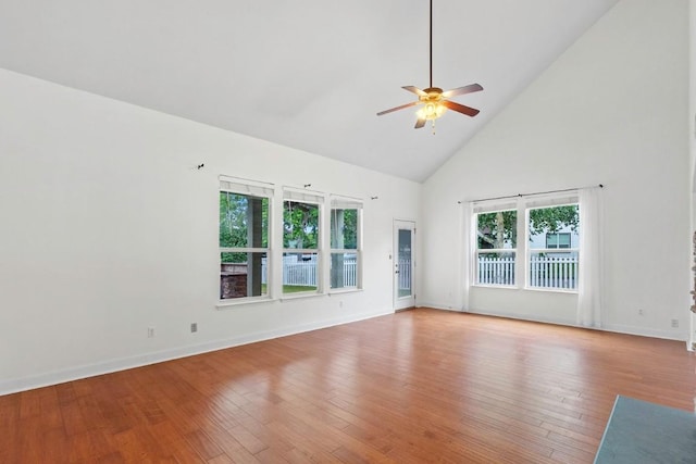 221 Mcgarity St, Kyle, TX 78640 - unfurnished room featuring high vaulted ceiling, ceiling fan, hardwood / wood-style floors, and baseboards
