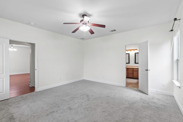 221 Mcgarity St, Kyle, TX 78640 - unfurnished bedroom featuring light colored carpet, baseboards, attic access, connected bathroom, and a ceiling fan