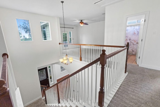 221 Mcgarity St, Kyle, TX 78640 - stairs featuring attic access, carpet, ceiling fan, a chandelier, and baseboards